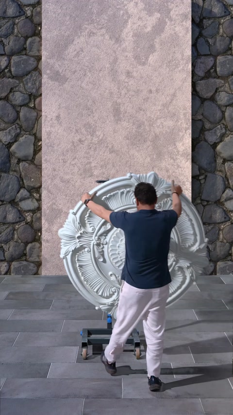 Un grande rosone viene posizionato davanti alla parete di applicazione.