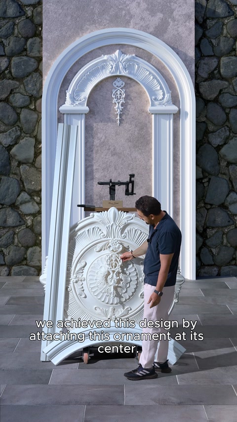 A relief ornament is placed at the center of the arched design to create a cohesive look.