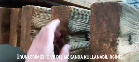 Hand touching and examining the rustic beam surface