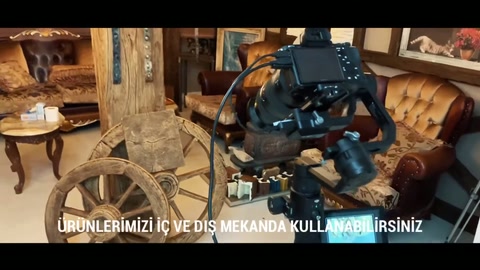 Rustic wheels and wood-grain components are displayed in front of filming equipment.