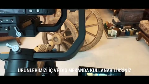 The camera in the workshop records the decorative wheel and beam arrangement from across the room.