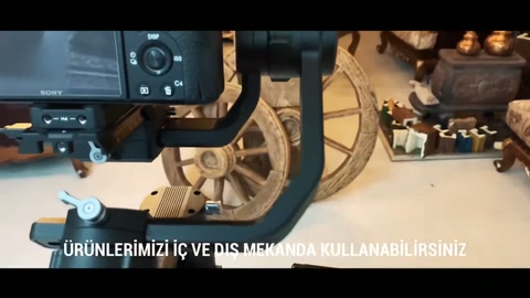 During professional filming, rustic wheels and beams are captured in frame.