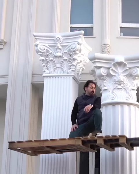 Two finished columns with capitals frame building entrance.