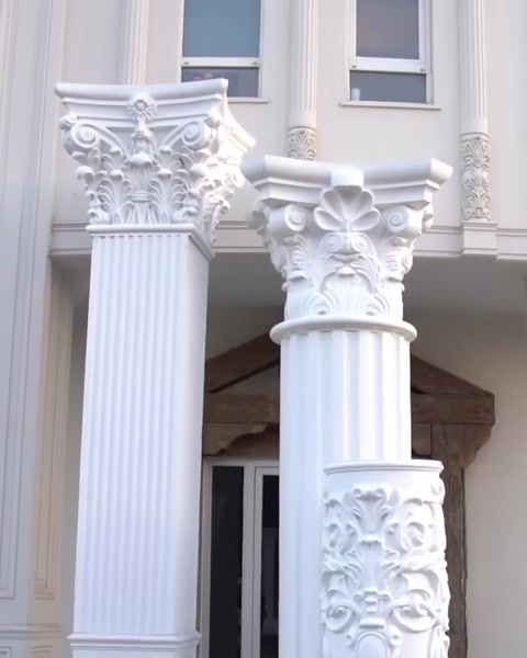 Two finished fluted columns with Corinthian capitals on facade.