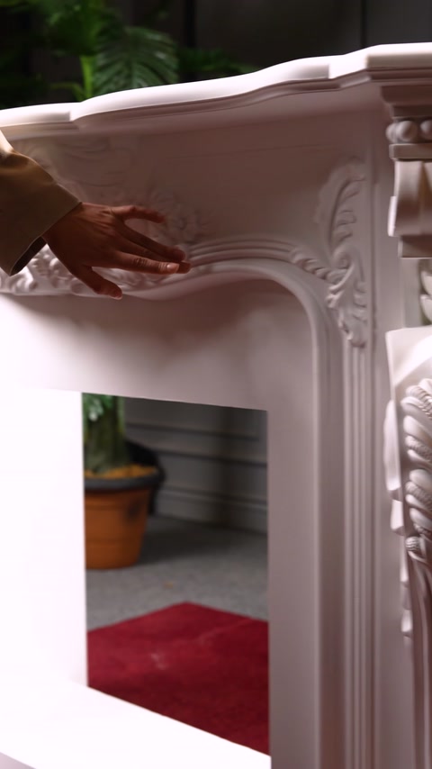 Curved crown and embossed decoration at fireplace corner