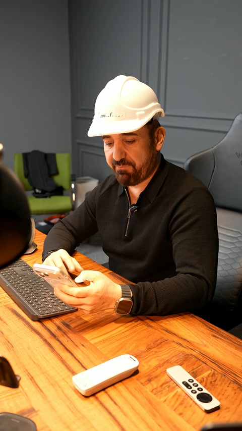 An expert presents the project at a desk with controls and computer.
