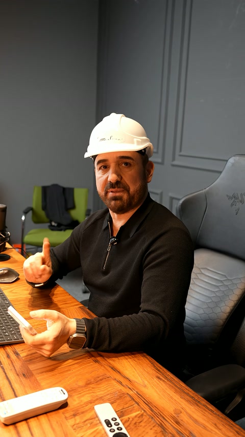 An expert in front of the camera demonstrates facade application approach.