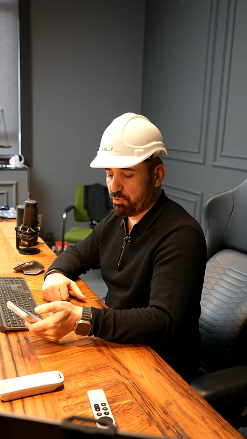 A presenter continues explaining the technical design process at the work desk.