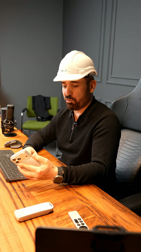 An expert presents the project at a desk with phone and computer.