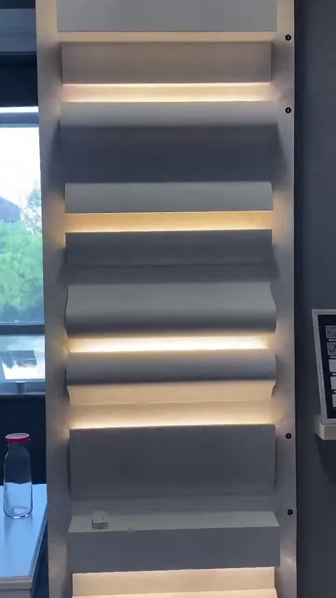 Su un'unità espositiva illuminata sono visibili sezioni di profili in poliuretano a gradini.
