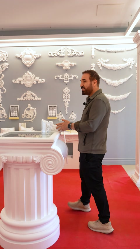 White baluster models are presented in front of a gray exhibition wall