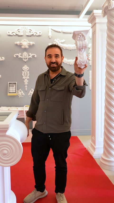 Server presents a large baluster example on the gray exhibition wall
