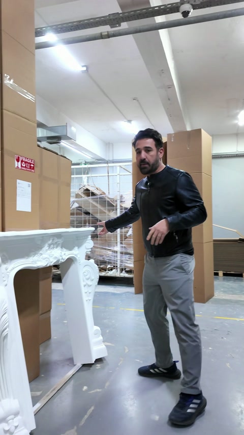 Cornice bianca decorata per camino esposta nel reparto imballaggio