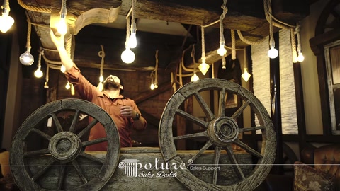 Decorative beams and wagon wheels displayed in a rustic interior