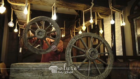 Polyurethane beams and decorative wheel models are presented in a rustic exhibition area.