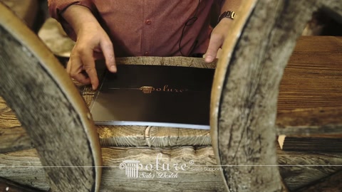 The open catalog is examined between wheel edges on a rustic table.