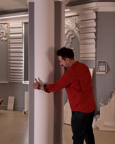 Presenter pointing along smooth shaft of half pilaster column panel