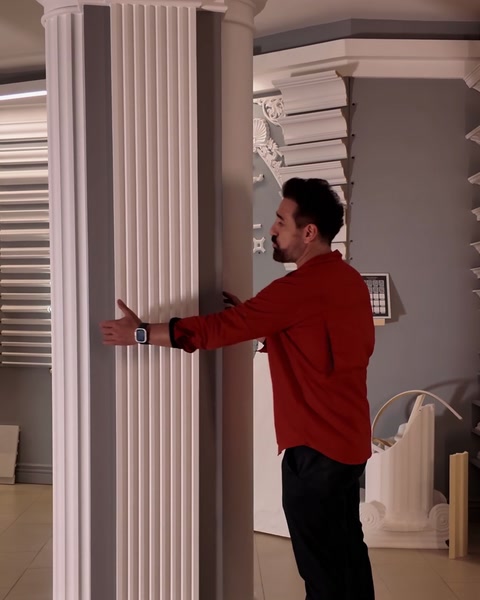 Hand running along flutes of the second pilaster column shaft