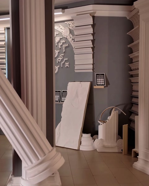 Round fluted column base detail resting on showroom floor