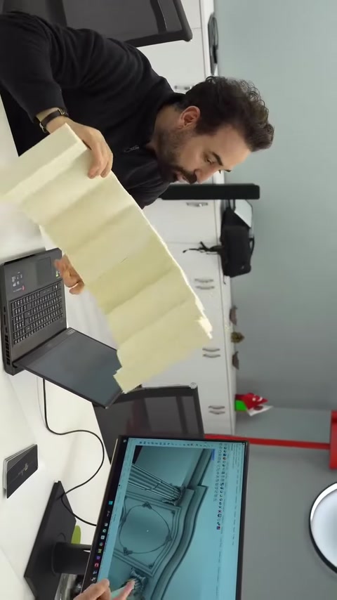 Un lungo campione di colonna scanalata viene presentato su un tavolo da lavoro.