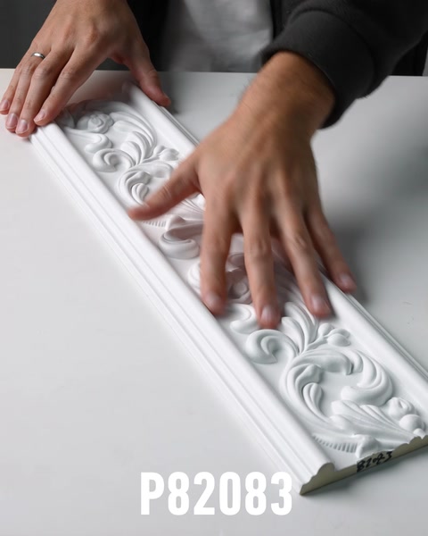 Hands running along ornate polyurethane wall molding surface texture