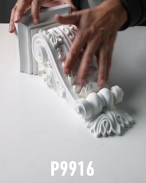 Hands inspecting polyurethane corbel bracket with rosette and scroll details