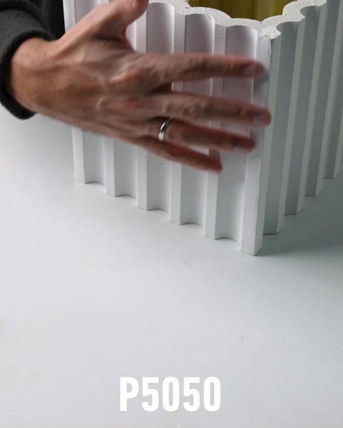 Hands resting on fluted white polyurethane column shaft