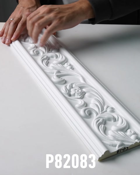 Hands sliding along decorative polyurethane frieze molding panel