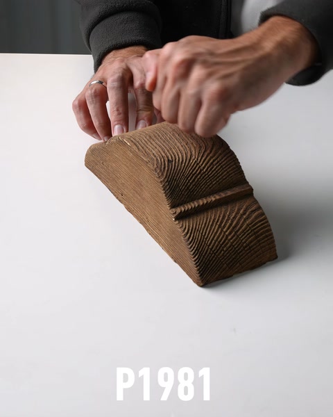 Hands touching wood-textured polyurethane corbel bracket surface