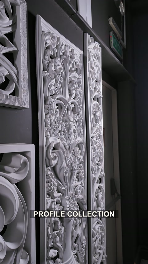 Tall carved floral panels displayed among smaller geometric wall ornaments