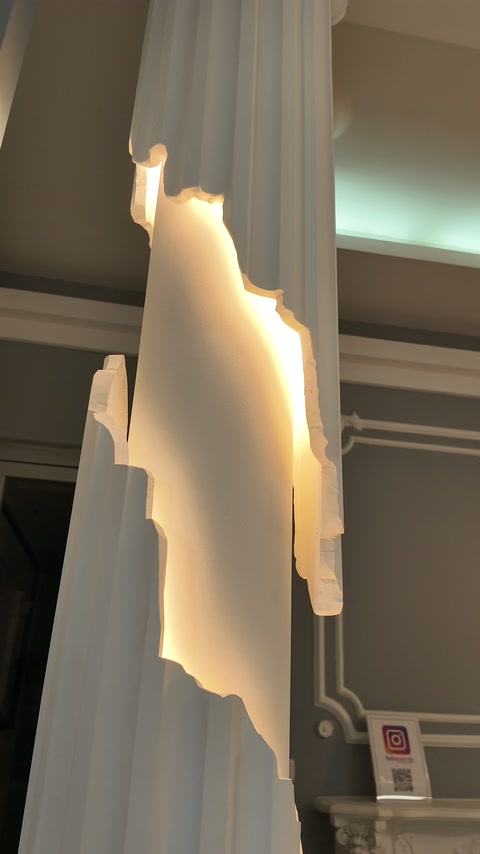 Side view of a fluted column with illuminated ornament samples