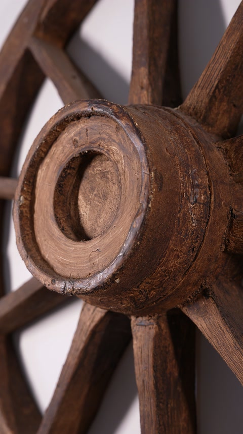 Close detail of a circular wood-effect ornament with radial spokes