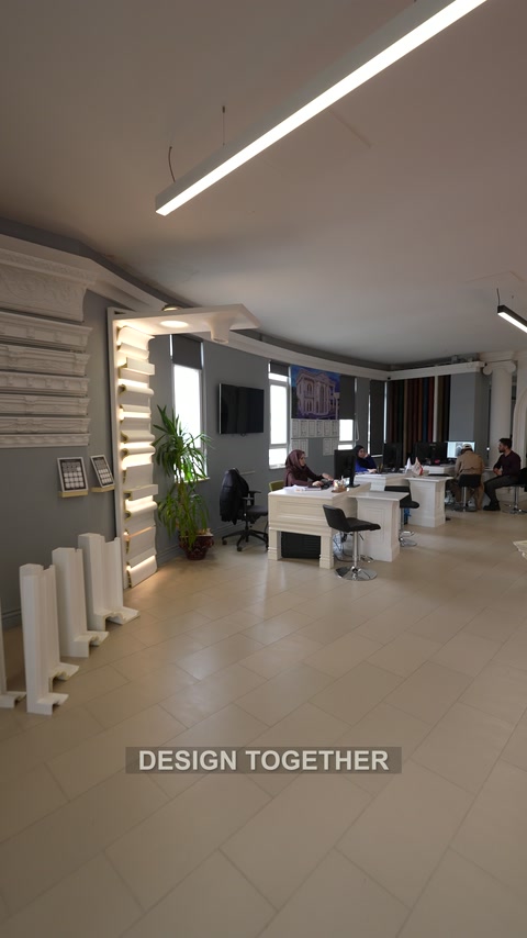 Wide showroom interior combining display walls workstations and product samples