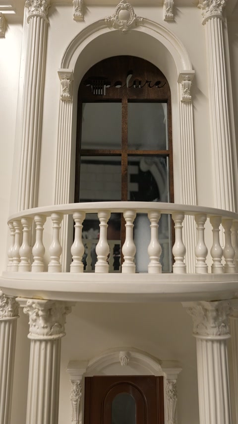 Finished facade featuring columns arched surrounds capitals and decorative balustrades