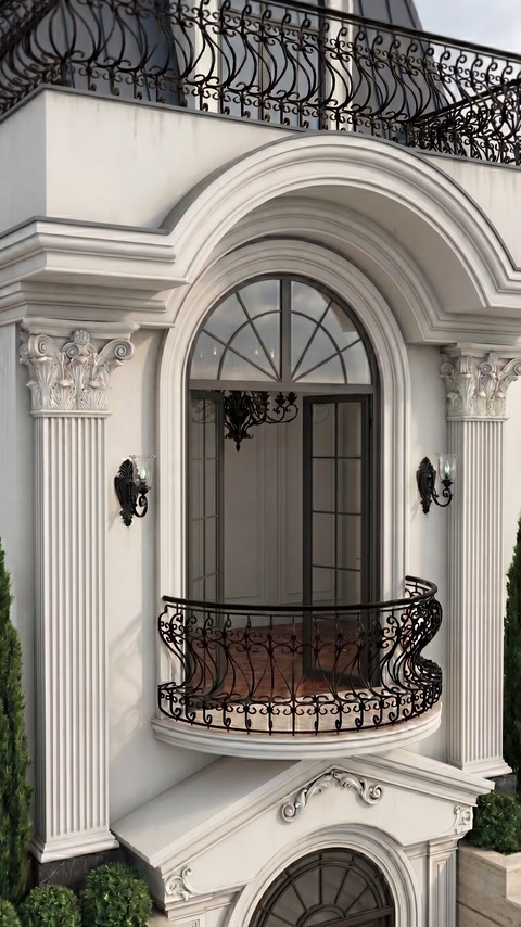 Arched entrance surround combines fluted pilasters, moldings, and decorative capitals.