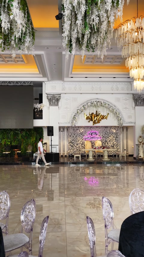 Decorative arch and ceiling details frame an illuminated event entrance.