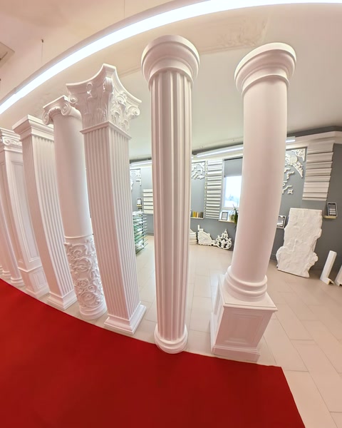 Row of ornate fluted columns lining the showroom floor