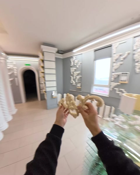 Showroom hallway view with columns leading toward archway