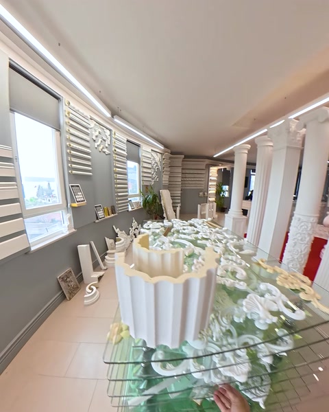 Large decorative corbel piece displayed on glass table