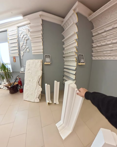 Wall-mounted decorative panel beside fluted showroom columns