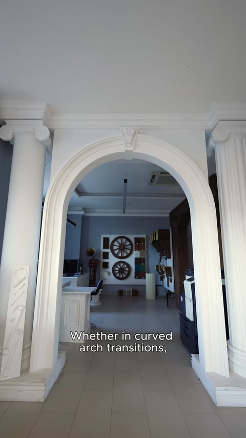 Curved decorative cornice surrounding a wide interior archway