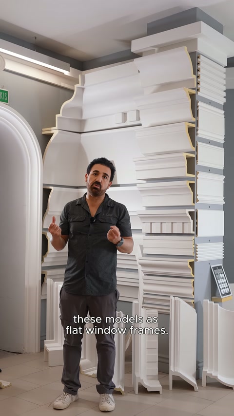 Staff member provides explanation in front of a tall surround panel in the product area.