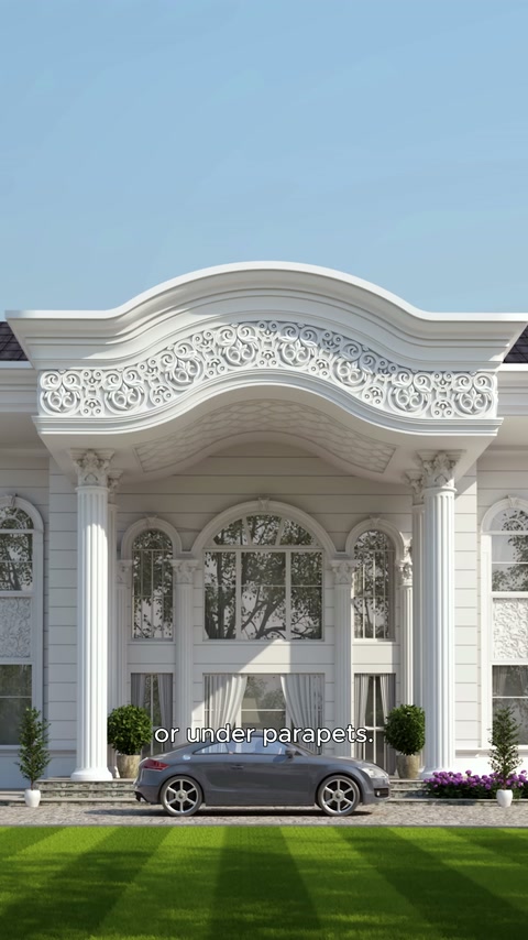 Carved cornice and curved soffit details at the columned residential entrance.