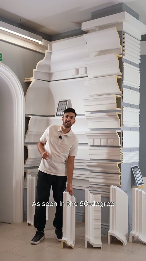 Staff member presents long corner profiles in vertical position in the showroom.
