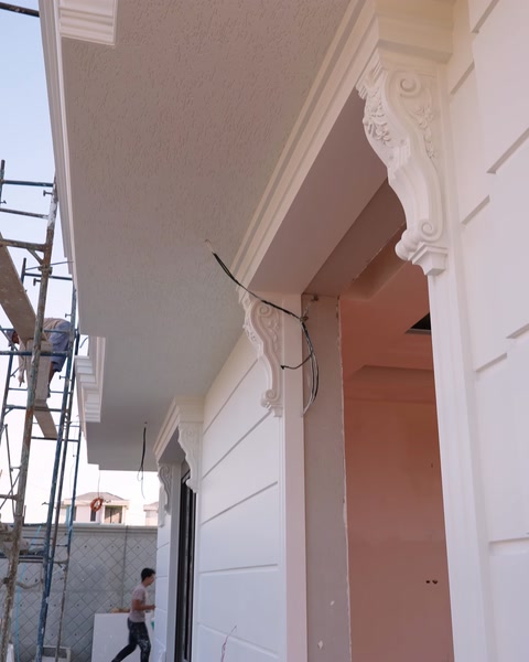 Preparation for installing a surround above a door opening in front of scaffolding