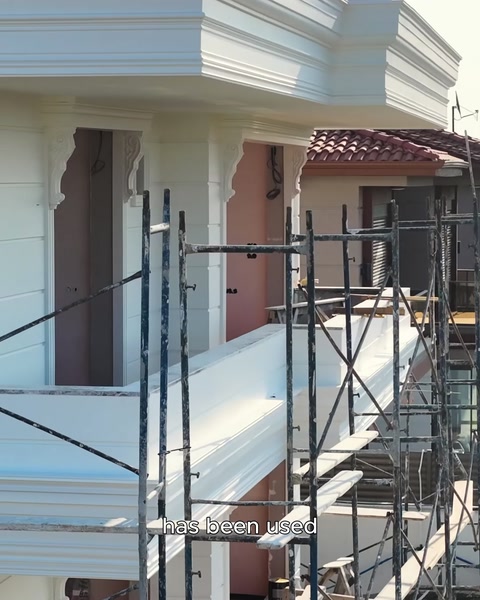 View of columns and the arched entrance on the exterior facade with scaffolding