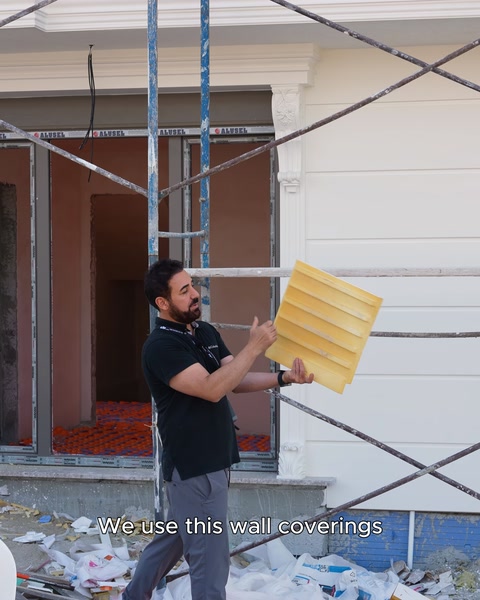 A yellow flexible polyurethane moulding profile is held in hand