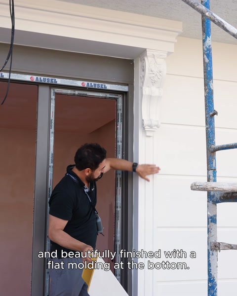 Finishing is completed below a window with a plain surround