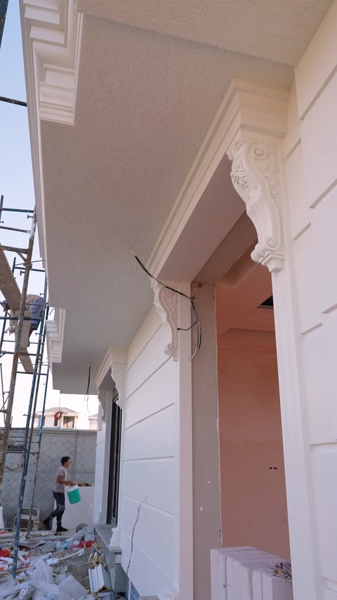 Decorative corbels arranged under curved arch and cladding