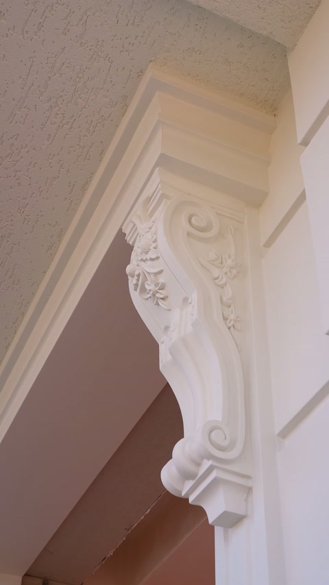 A carved corbel and surrounding profiles at the eave corner are shown in close detail.